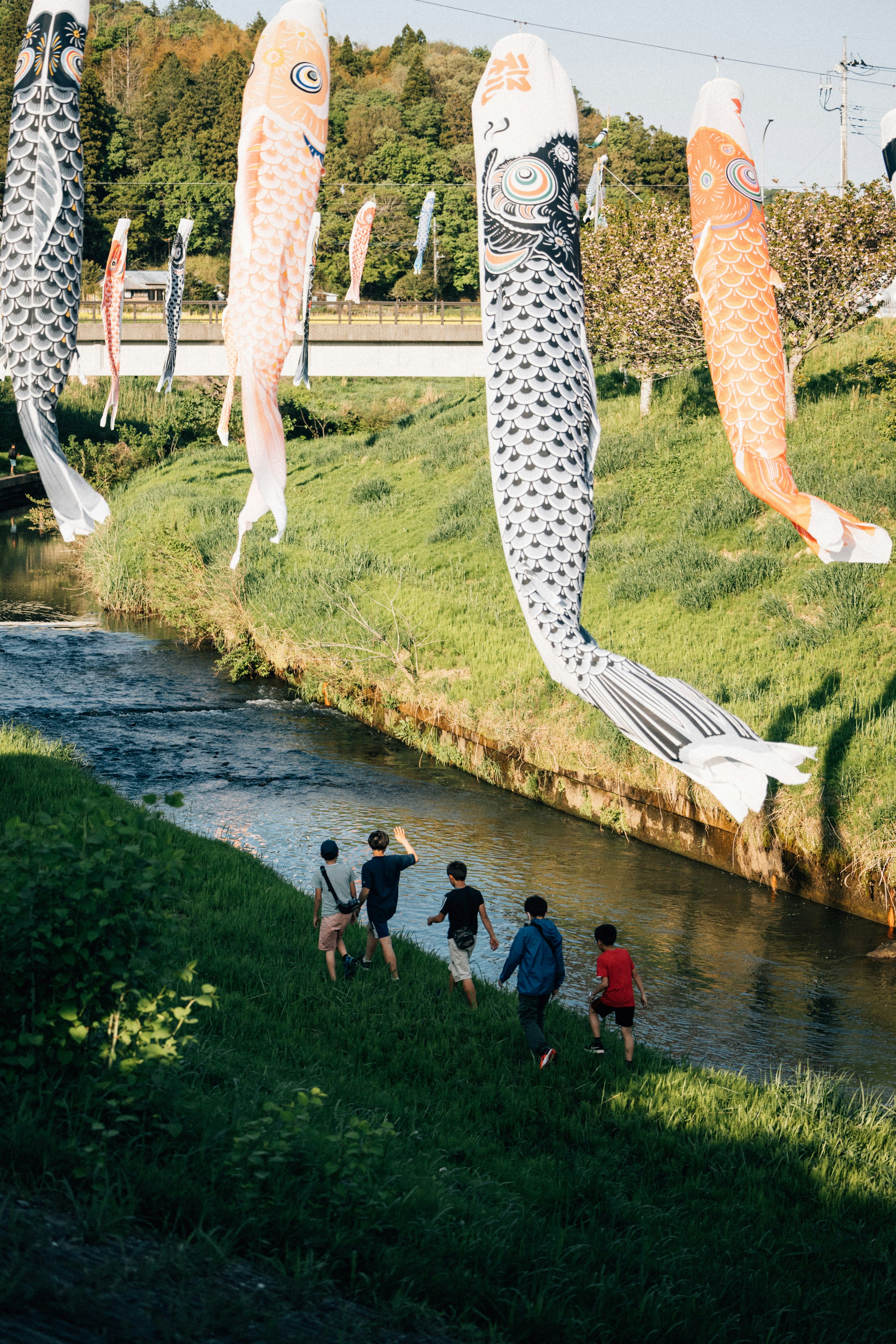 A group of people standing next to a river