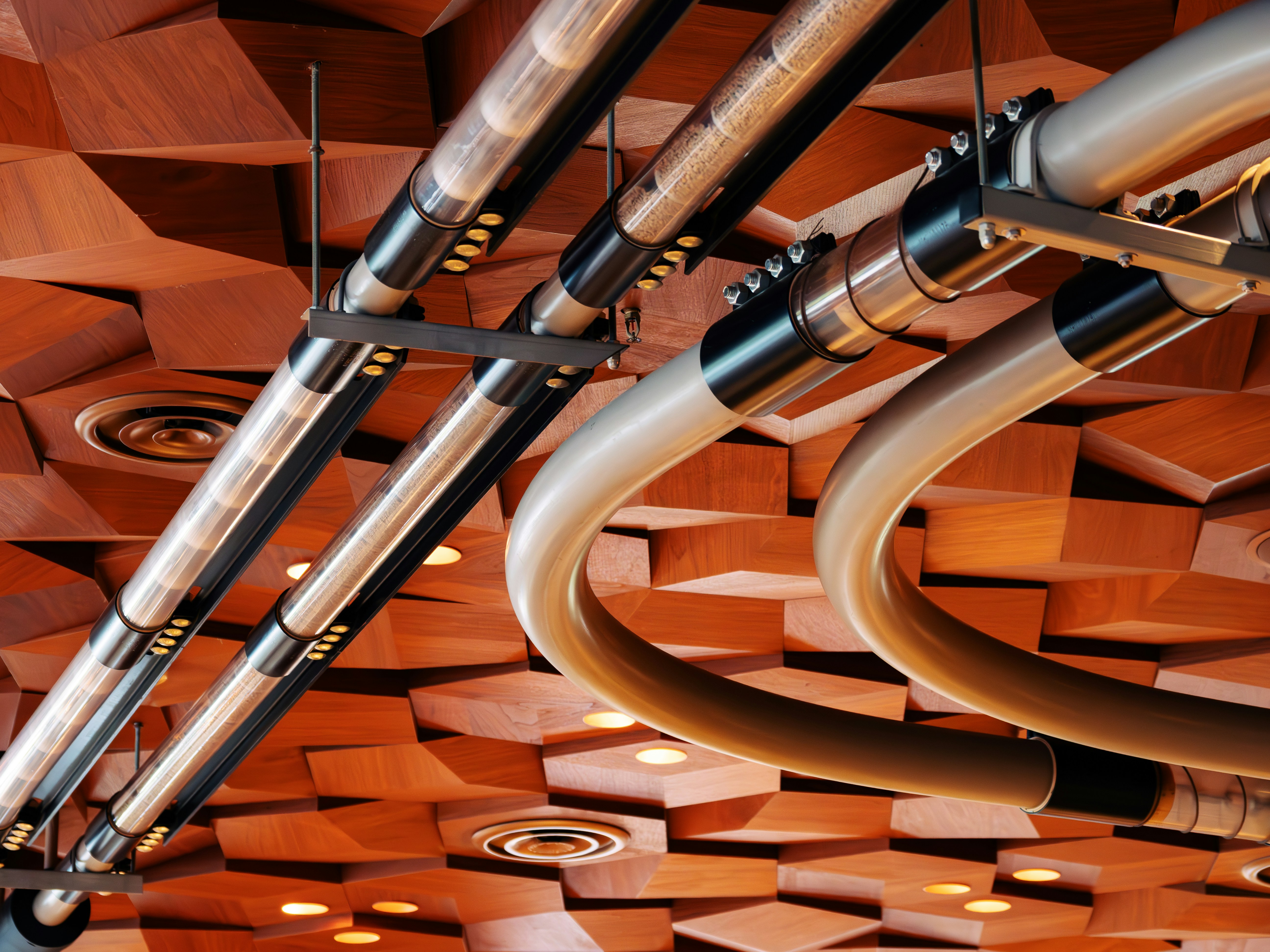 A ceiling made of wood and metal pipes