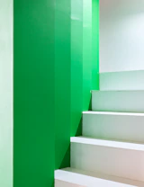 A white staircase with green walls and white steps