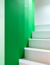 A white staircase with green walls and white steps