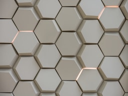 A close up of a wall made of hexagonal tiles