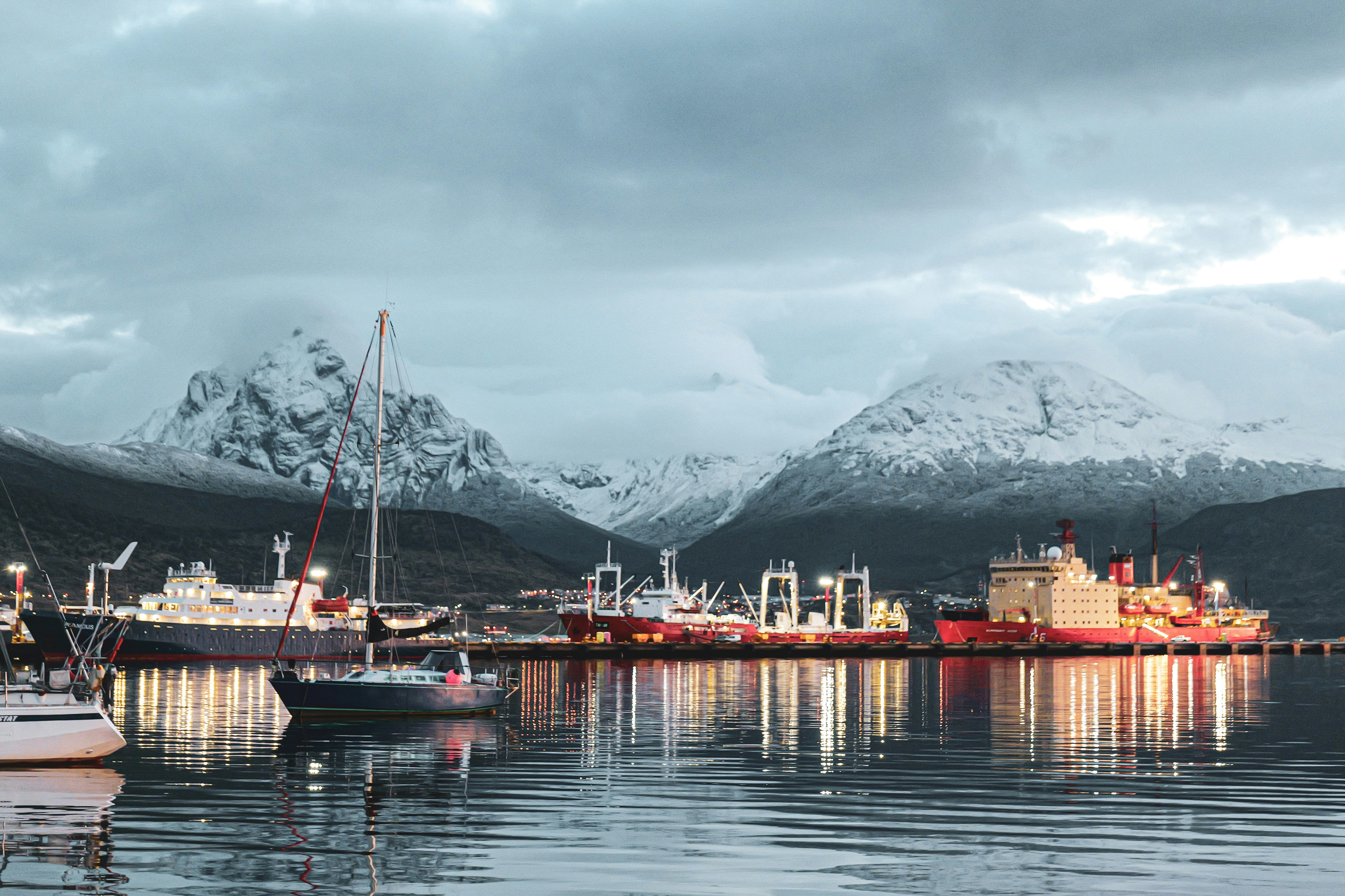 A group of boats floating on top of a body of water