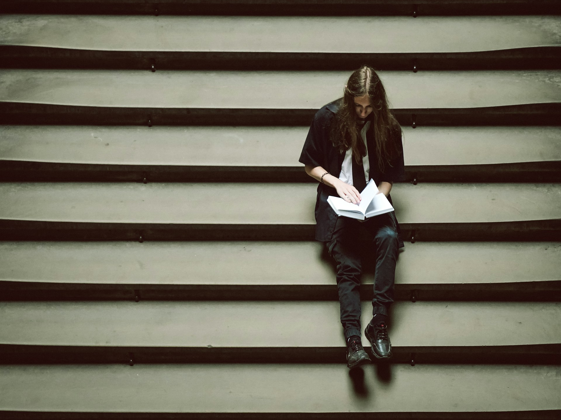 A person sitting on a set of stairs