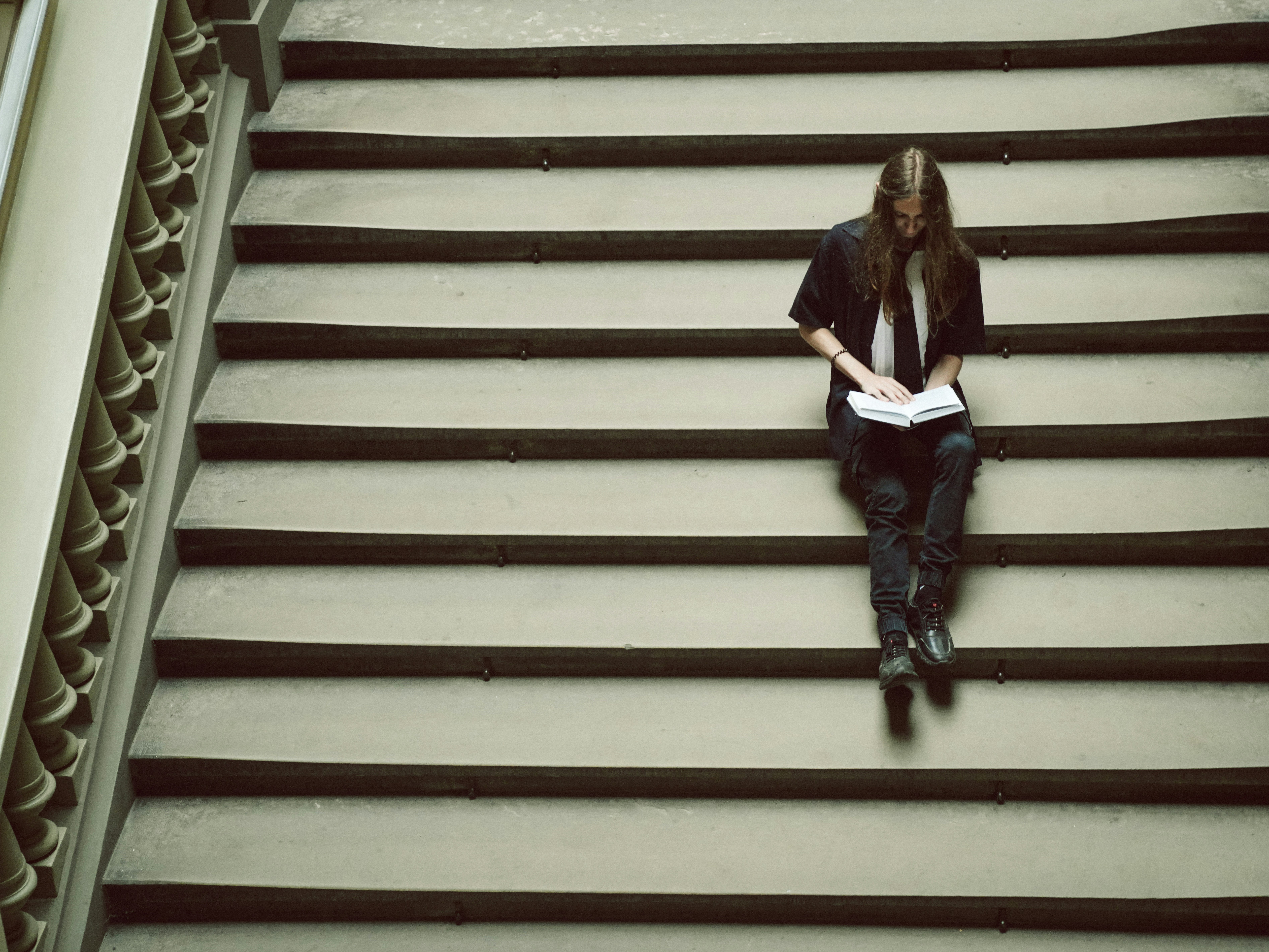 A woman is sitting on a set of stairs