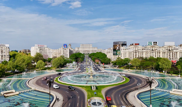 A view of a city with a fountain in the middle