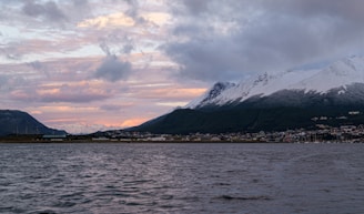 A body of water with mountains in the background