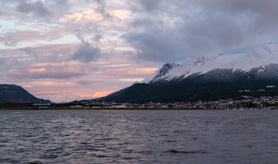 A body of water with mountains in the background