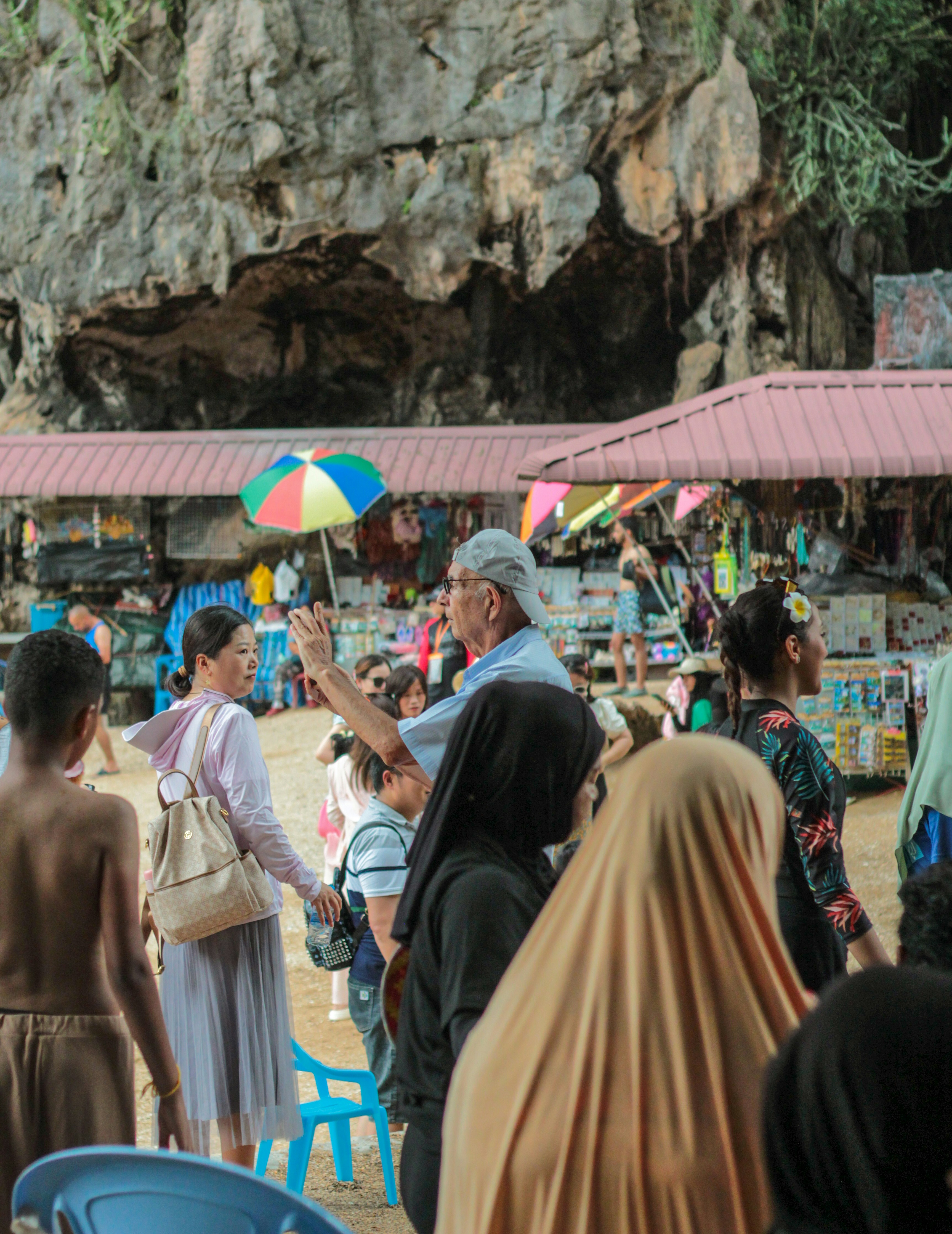 A group of people standing on top of a sandy beach