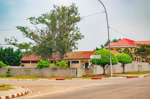 A street corner with a red roof and trees