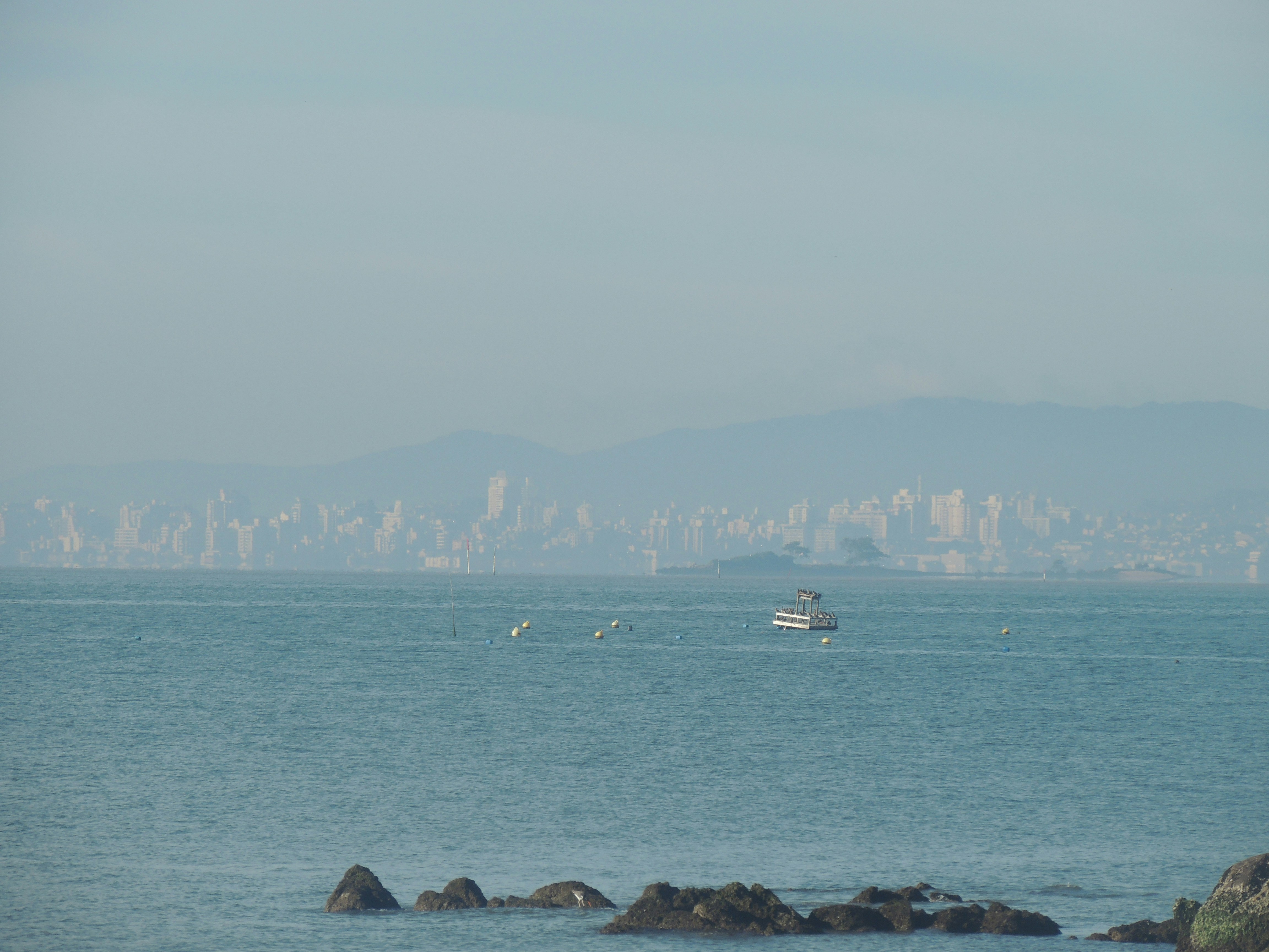 A large body of water with a boat in the distance
