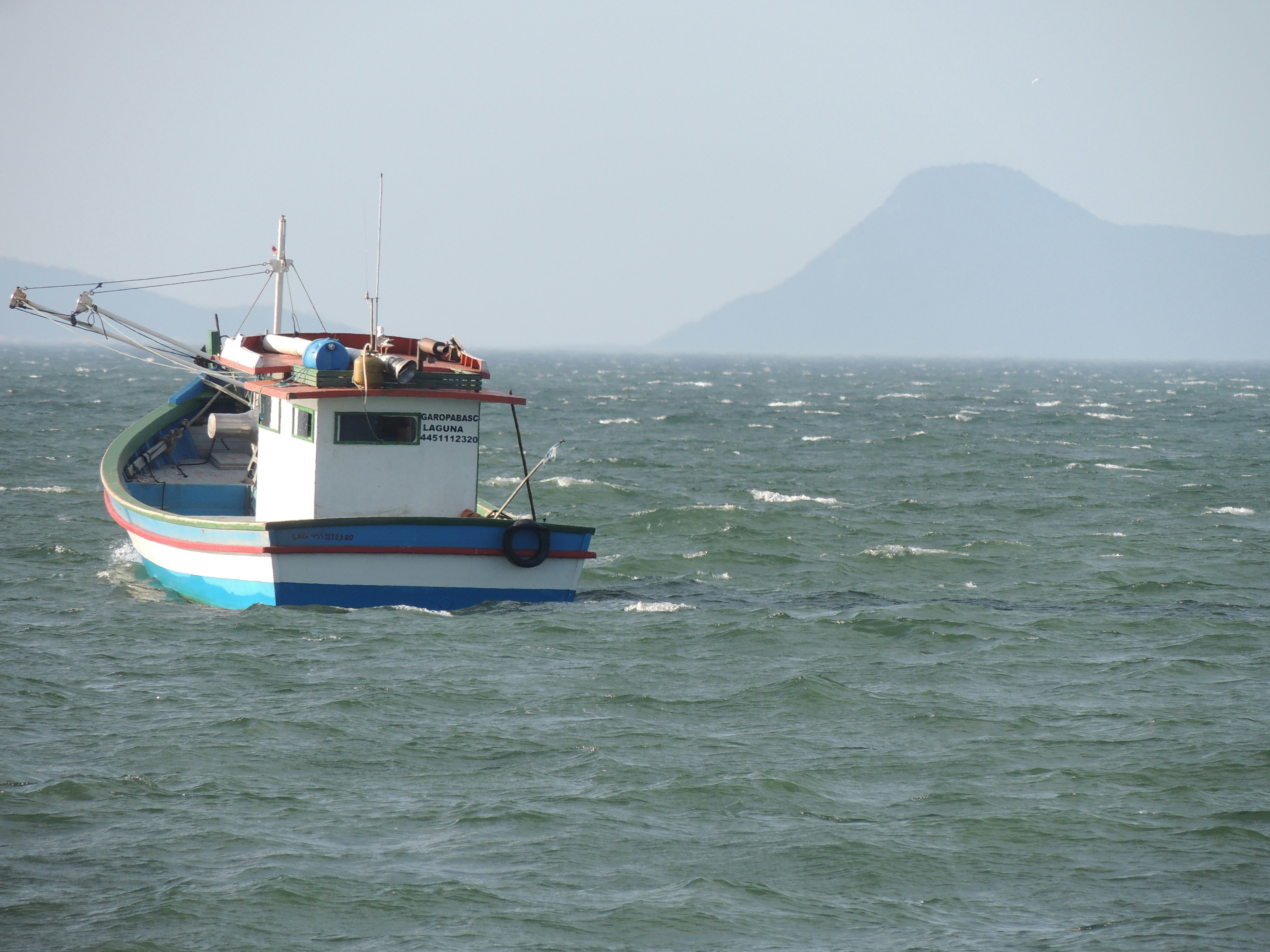 A boat in the middle of a body of water