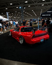 A red sports car parked in a showroom