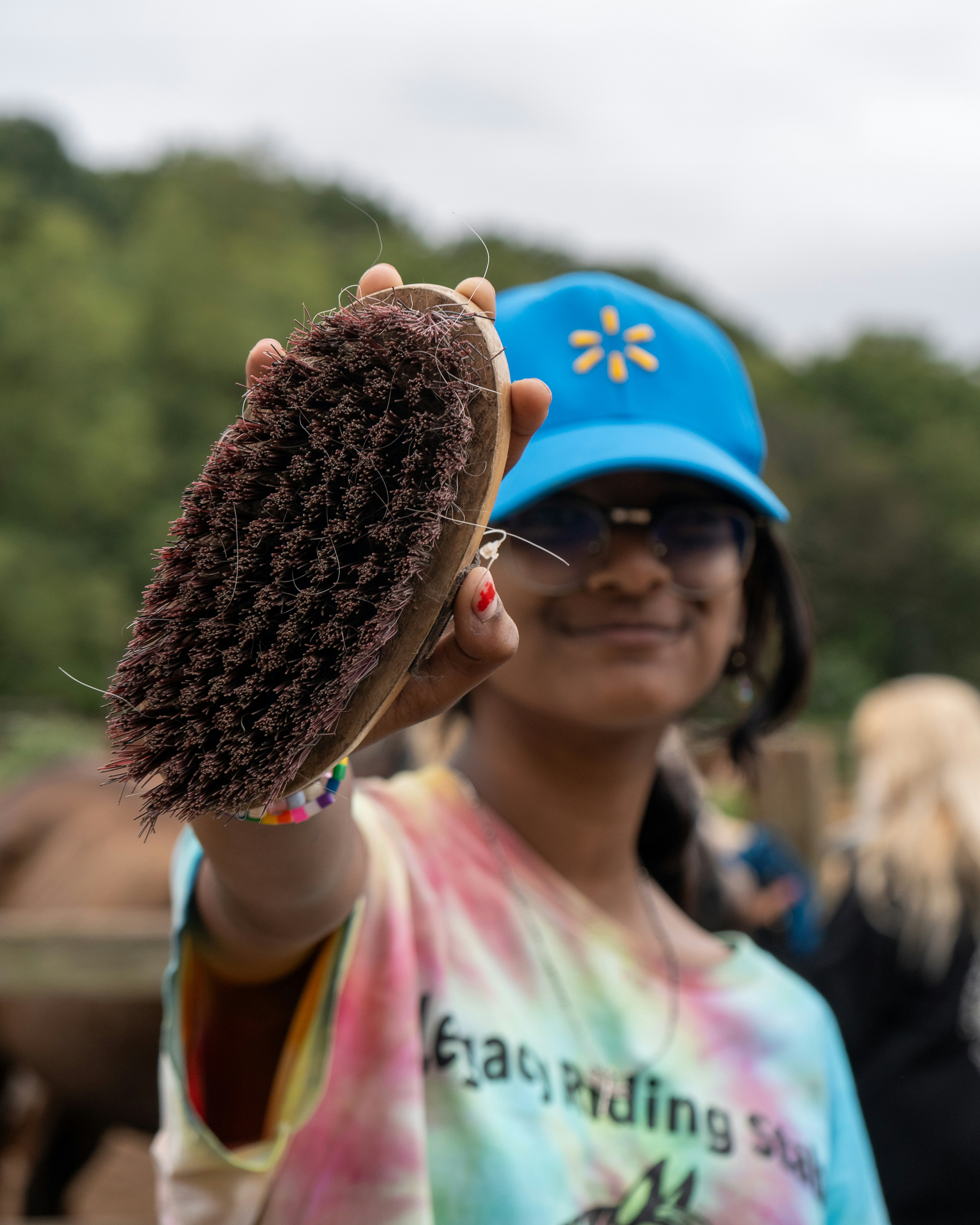 A woman holding a brush in her right hand
