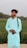 A man with a camera standing in front of a field