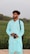 A man with a camera standing in front of a field
