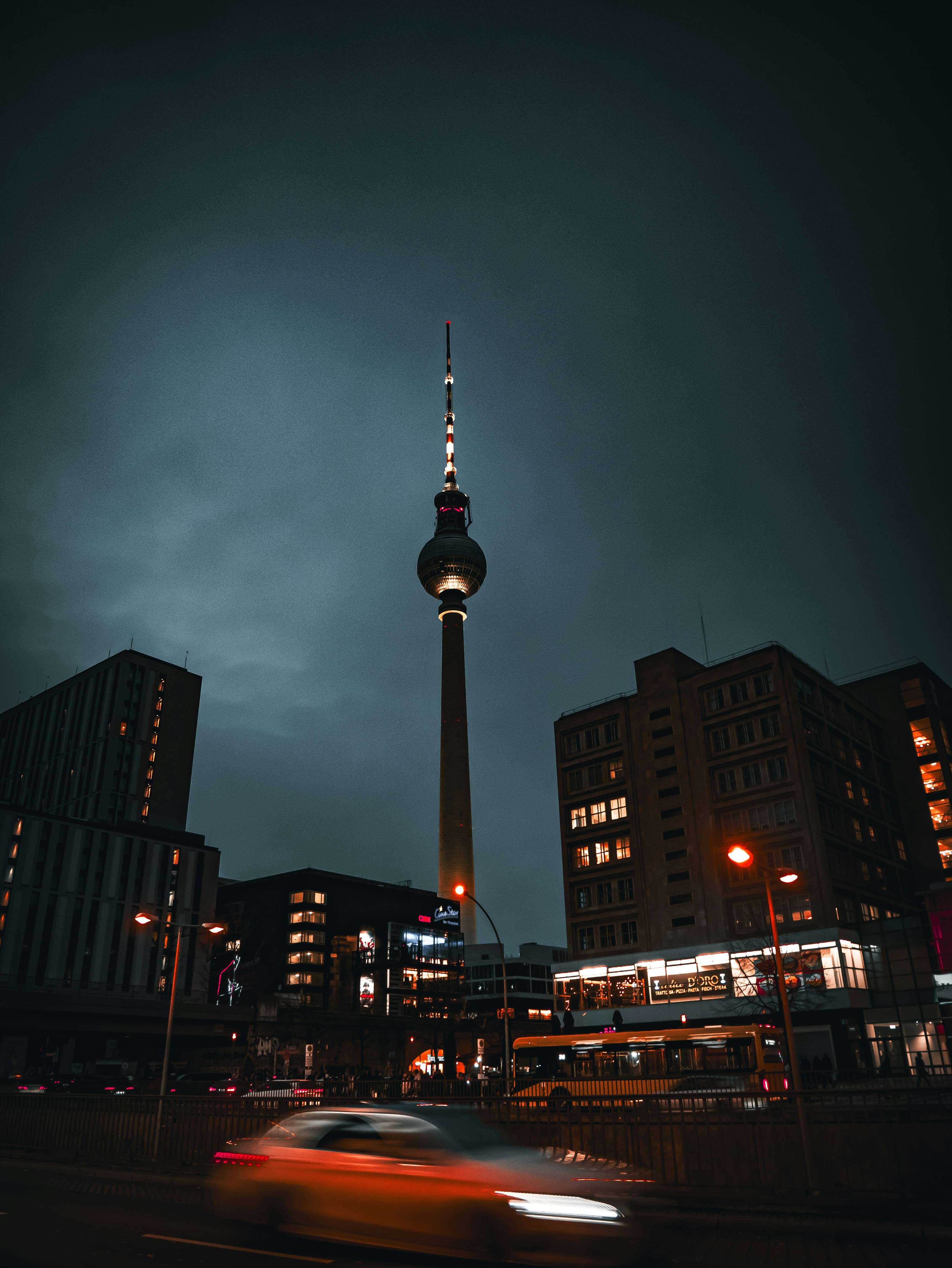A car driving down a street next to tall buildings