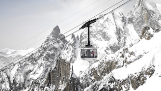 A ski lift going up a snowy mountain