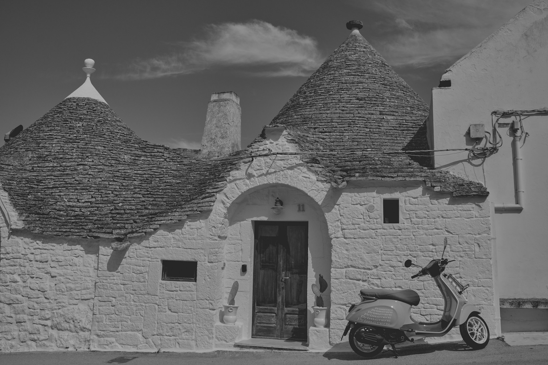 A scooter parked in front of a white building