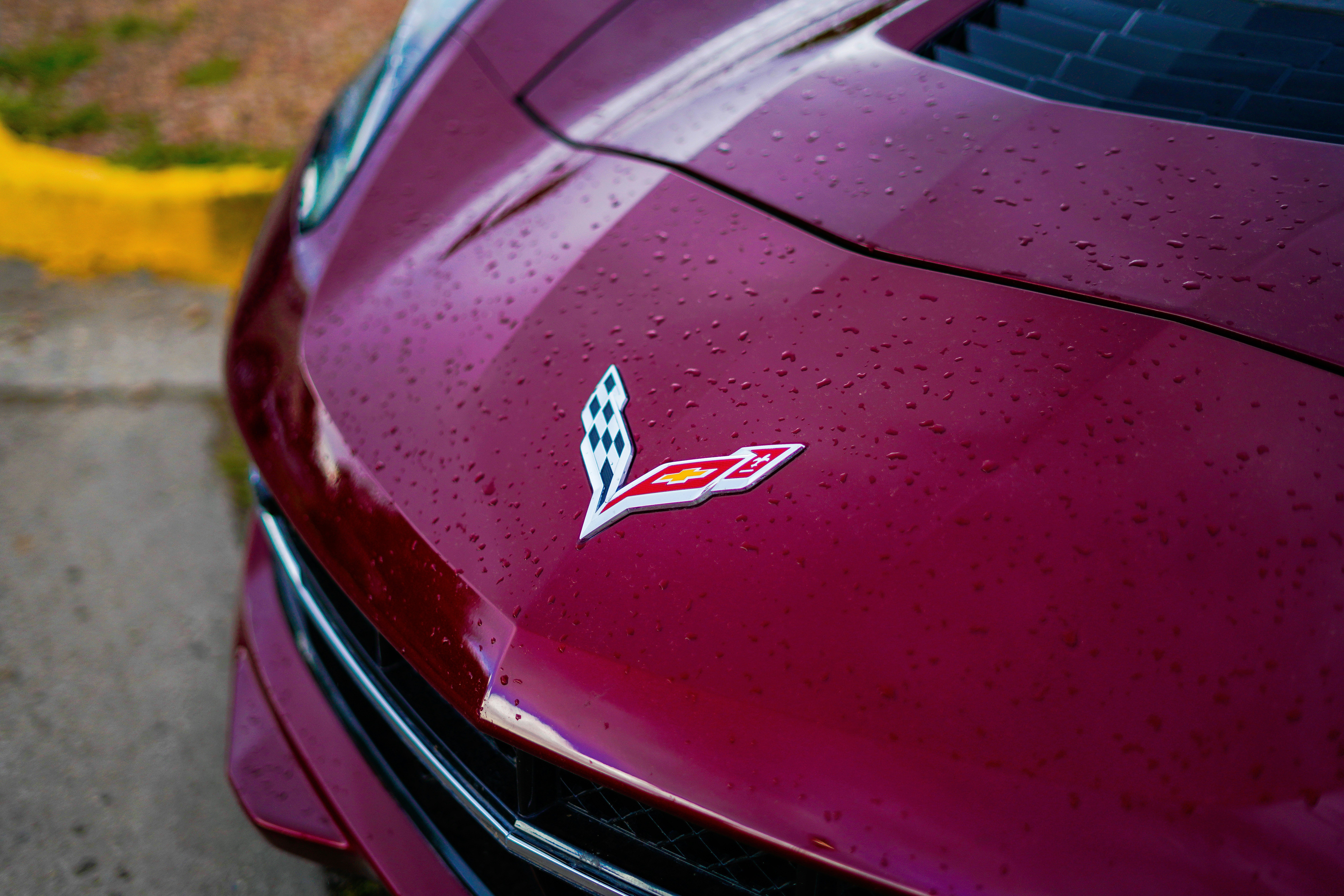 A close up of the hood of a red car