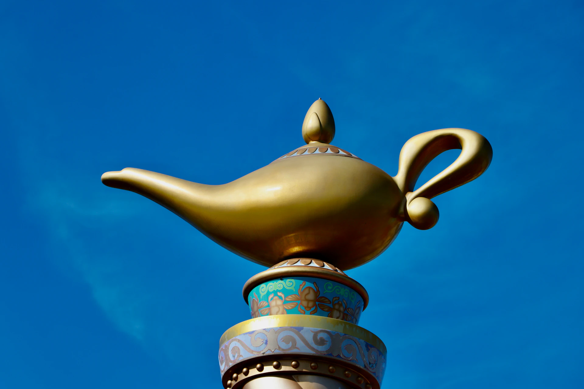 A golden teapot on top of a building