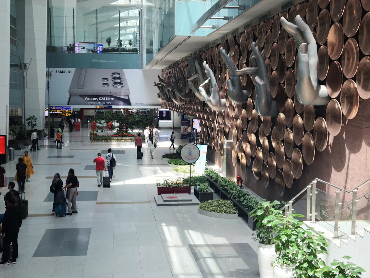 Travellers walking through the concourse of Indira Gandhi International Airport, New Delhi.