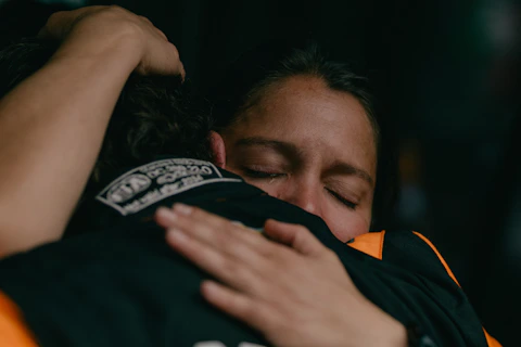 A woman is hugging another woman in a hug