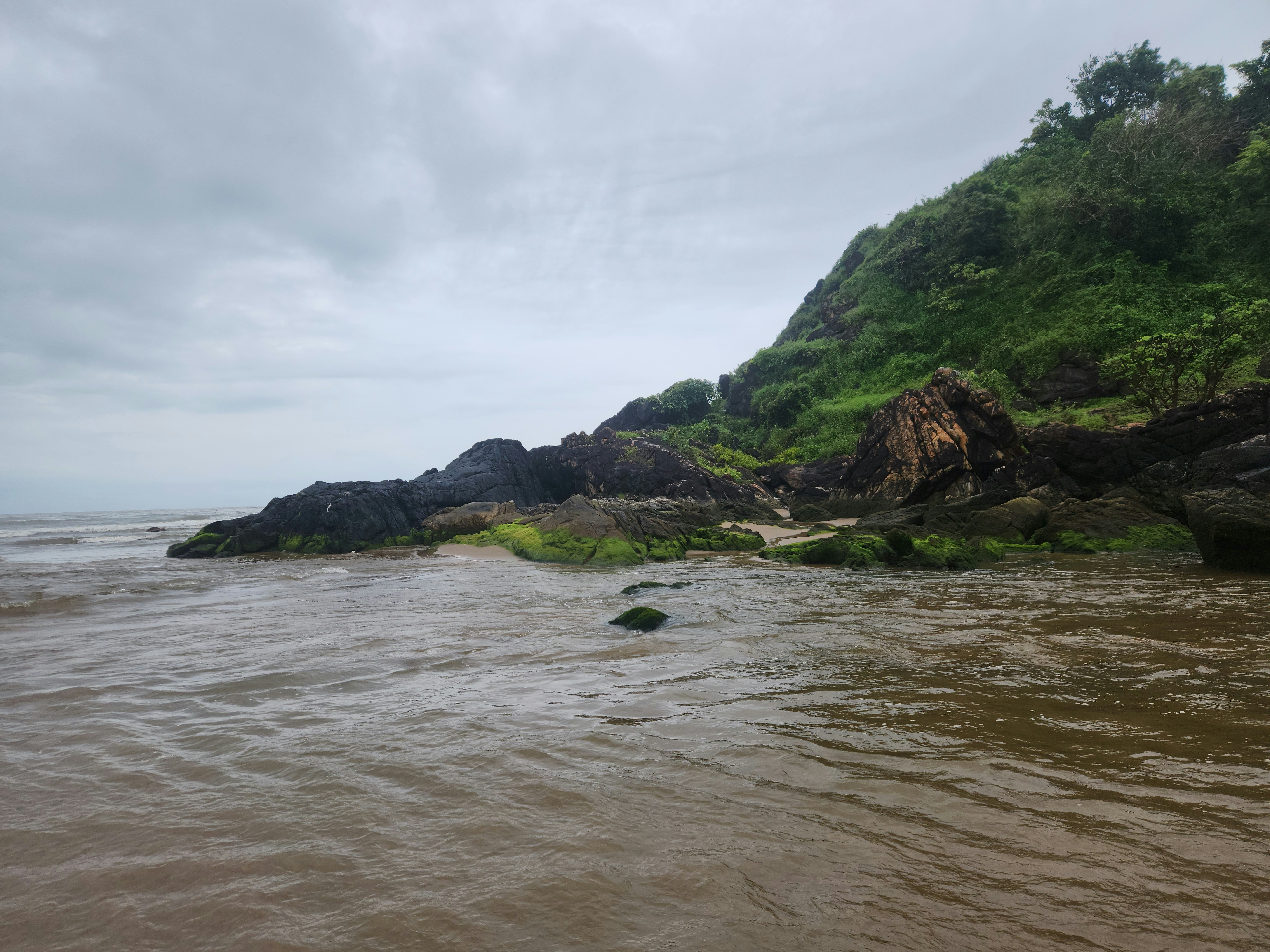A body of water with a small island in the middle of it