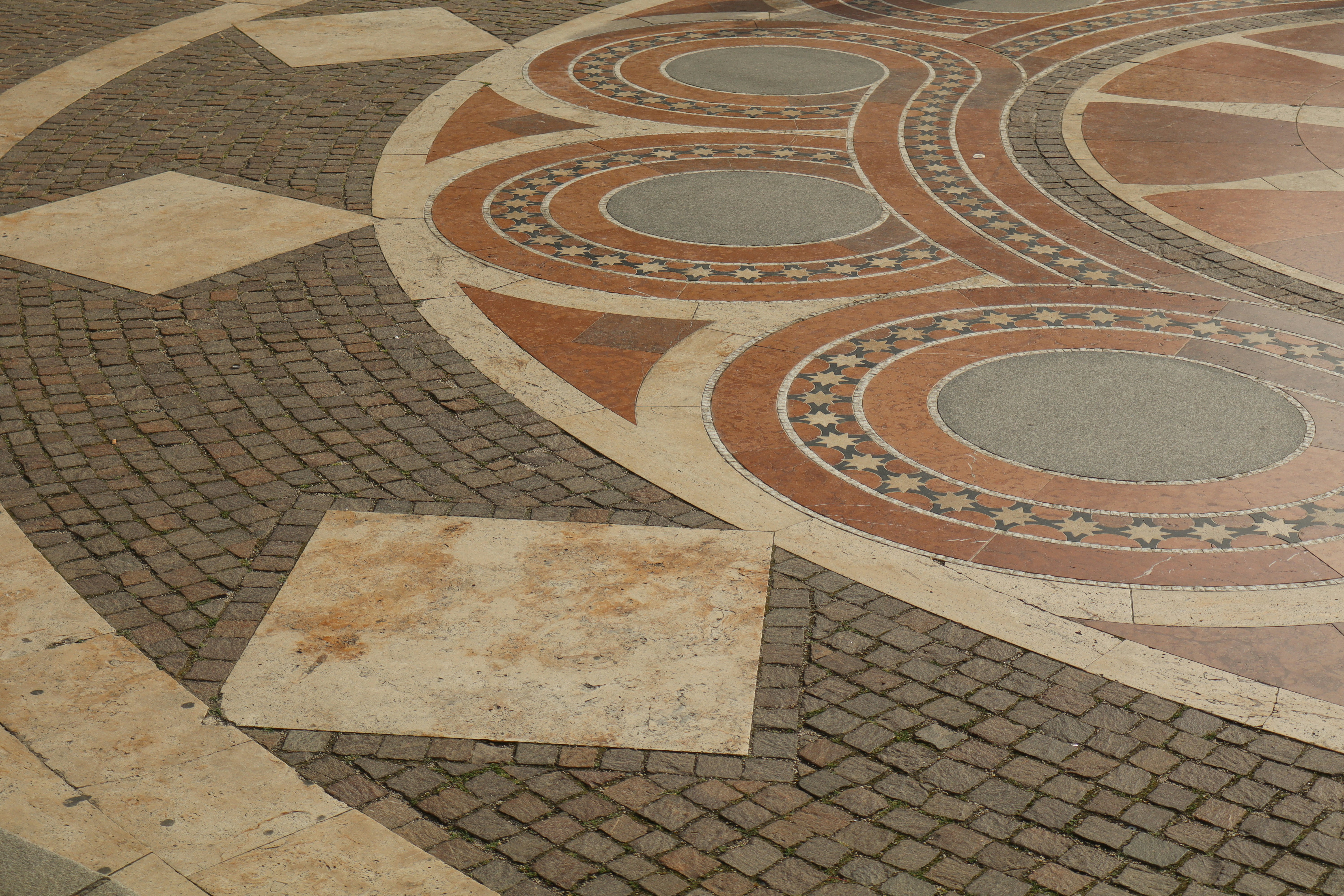 A man walking down a street next to a building