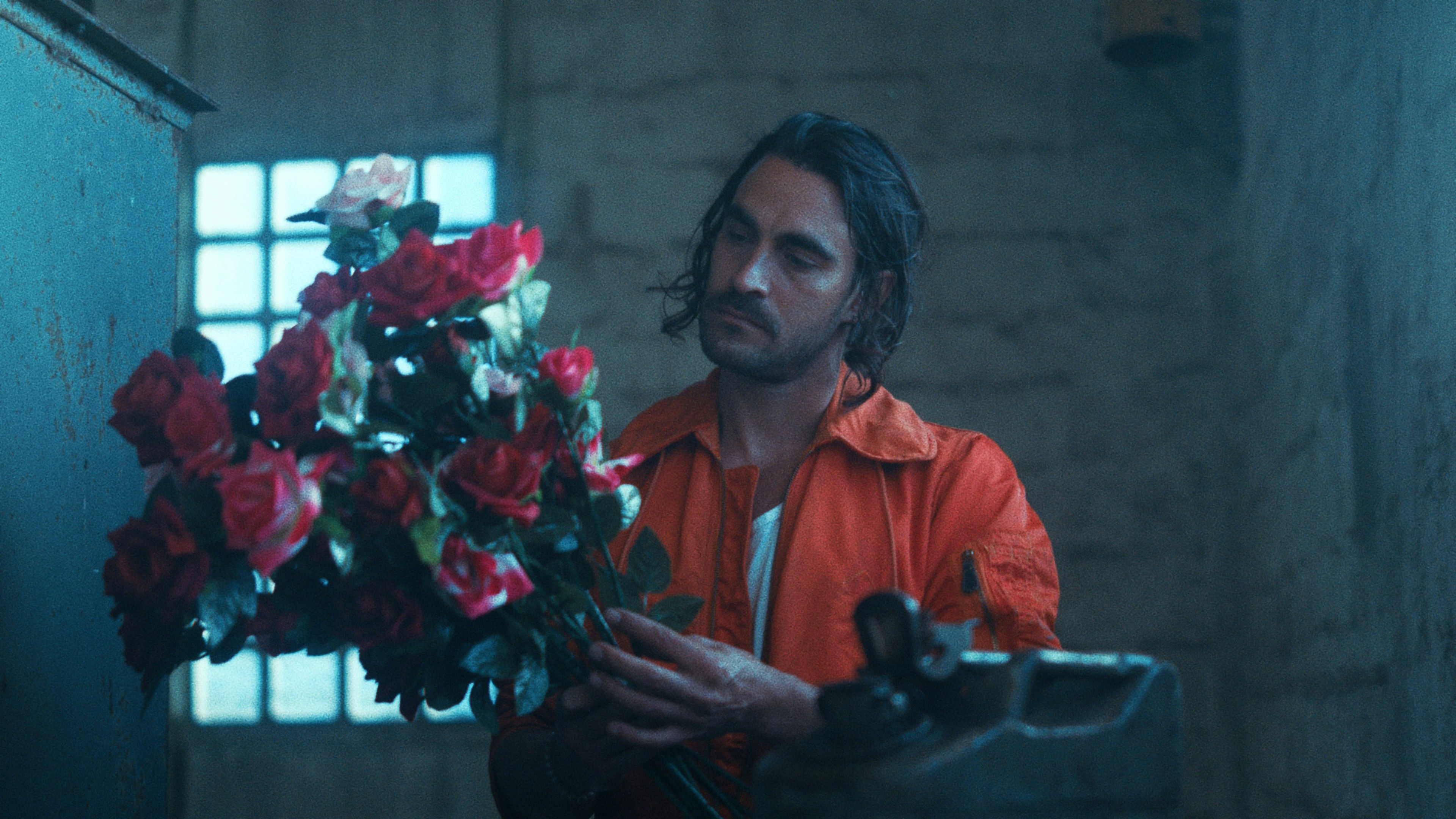 A man holding a bunch of flowers in his hands