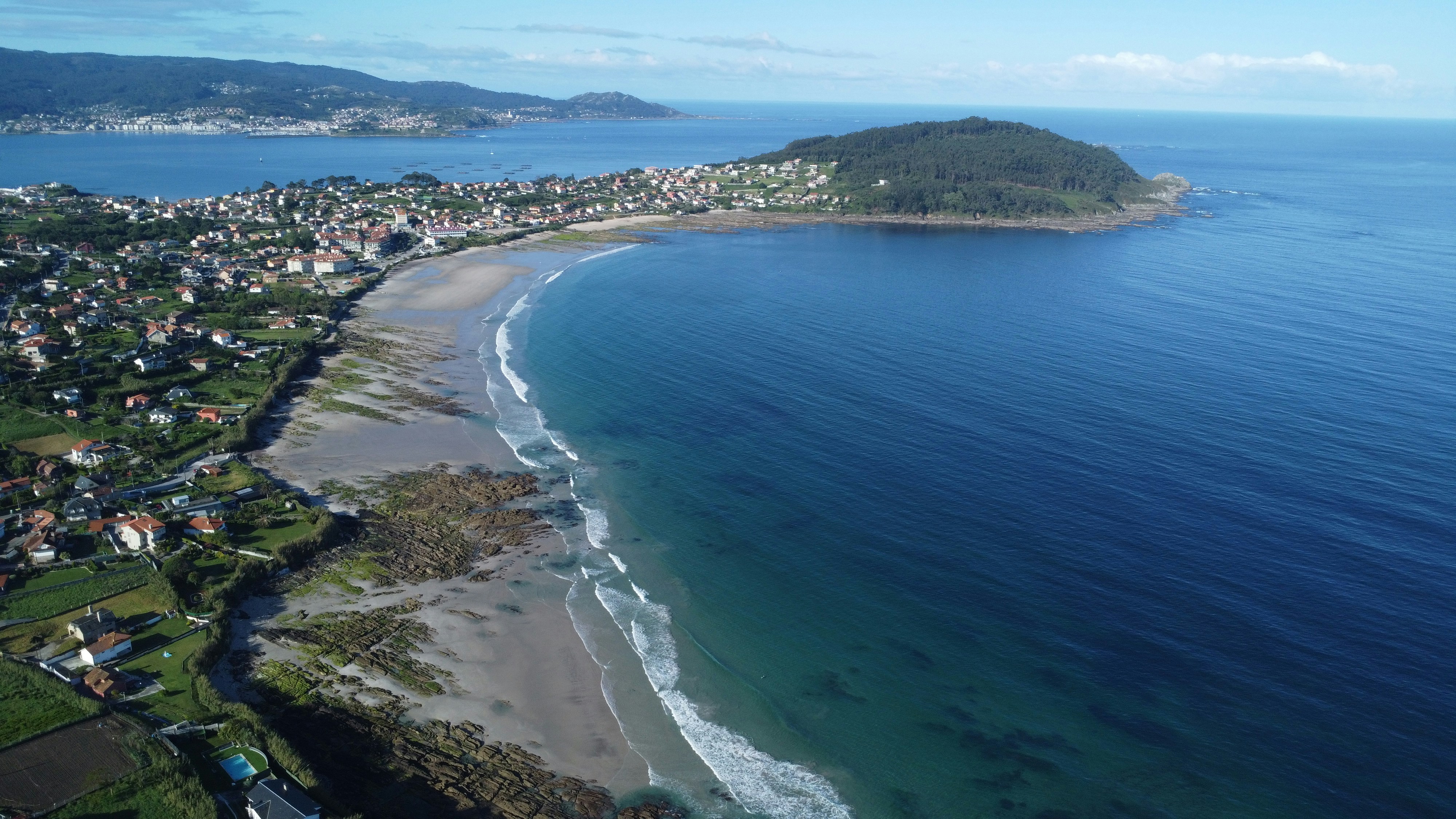 An aerial view of a beach and a city