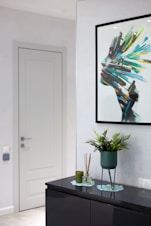 A living room with a large picture hanging on the wall