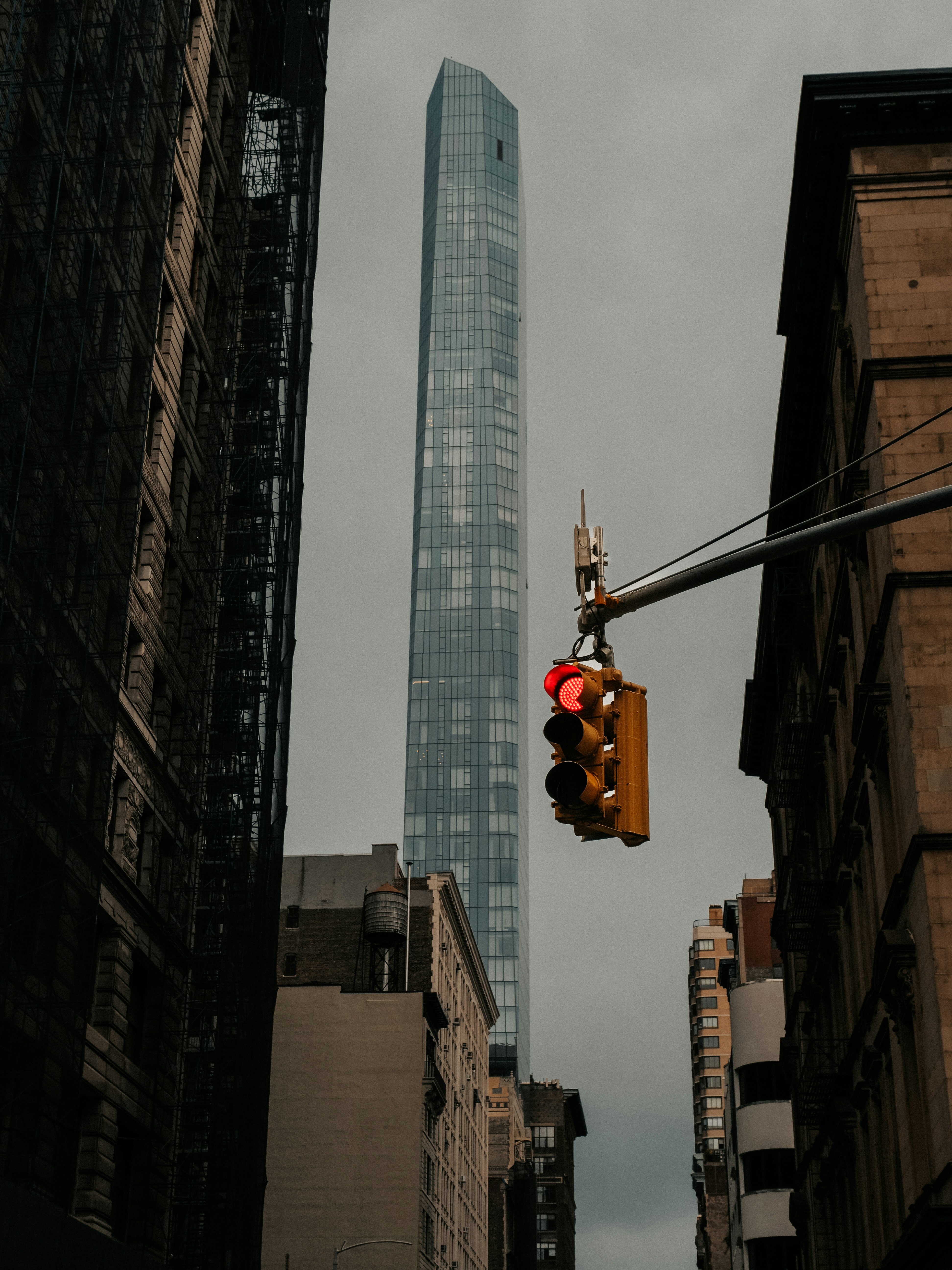 A traffic light hanging from the side of a building