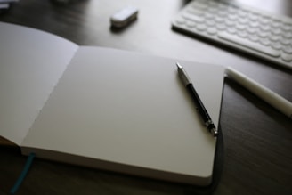 An open notebook with a pen on top of it