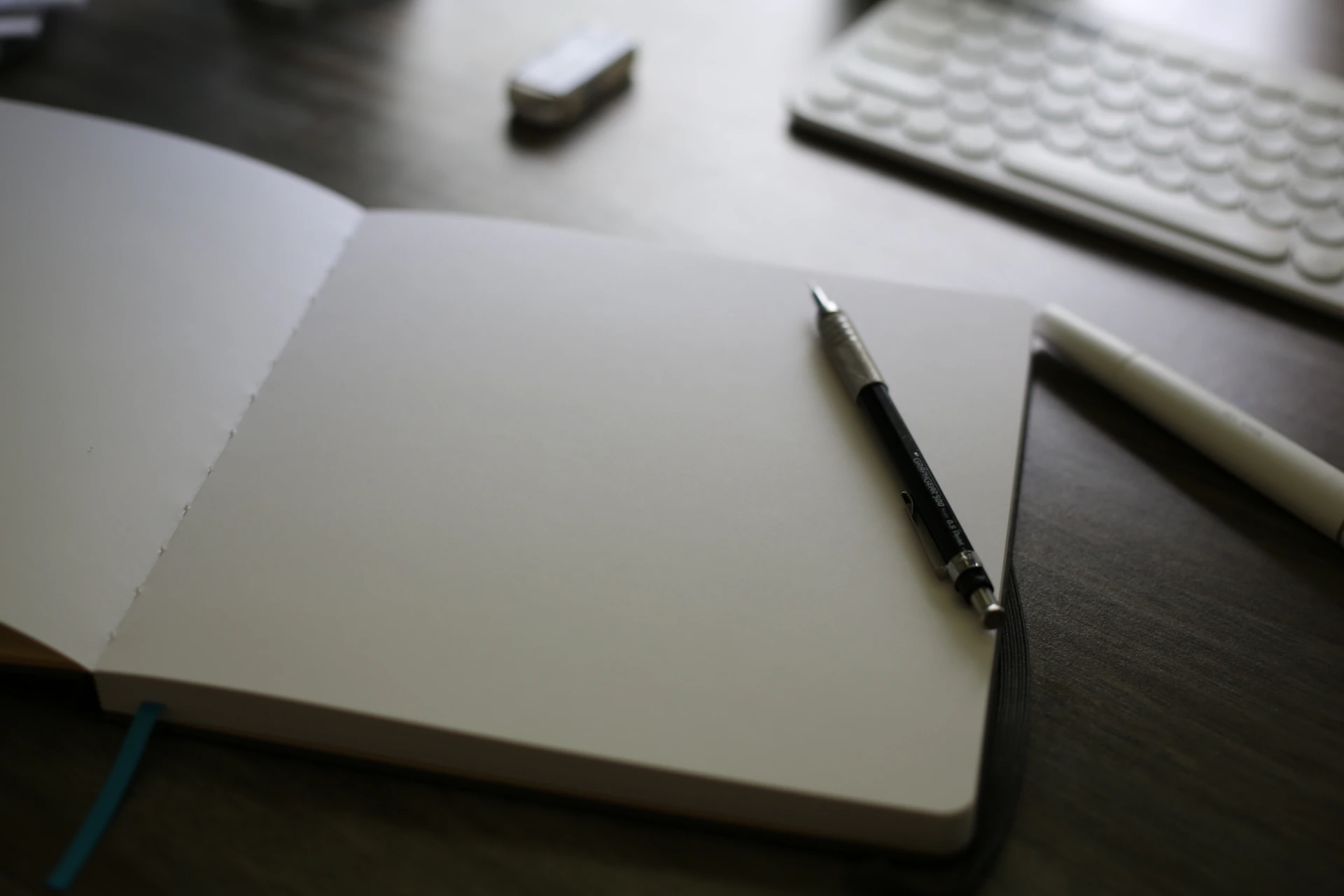 An open notebook with a pen on top of it