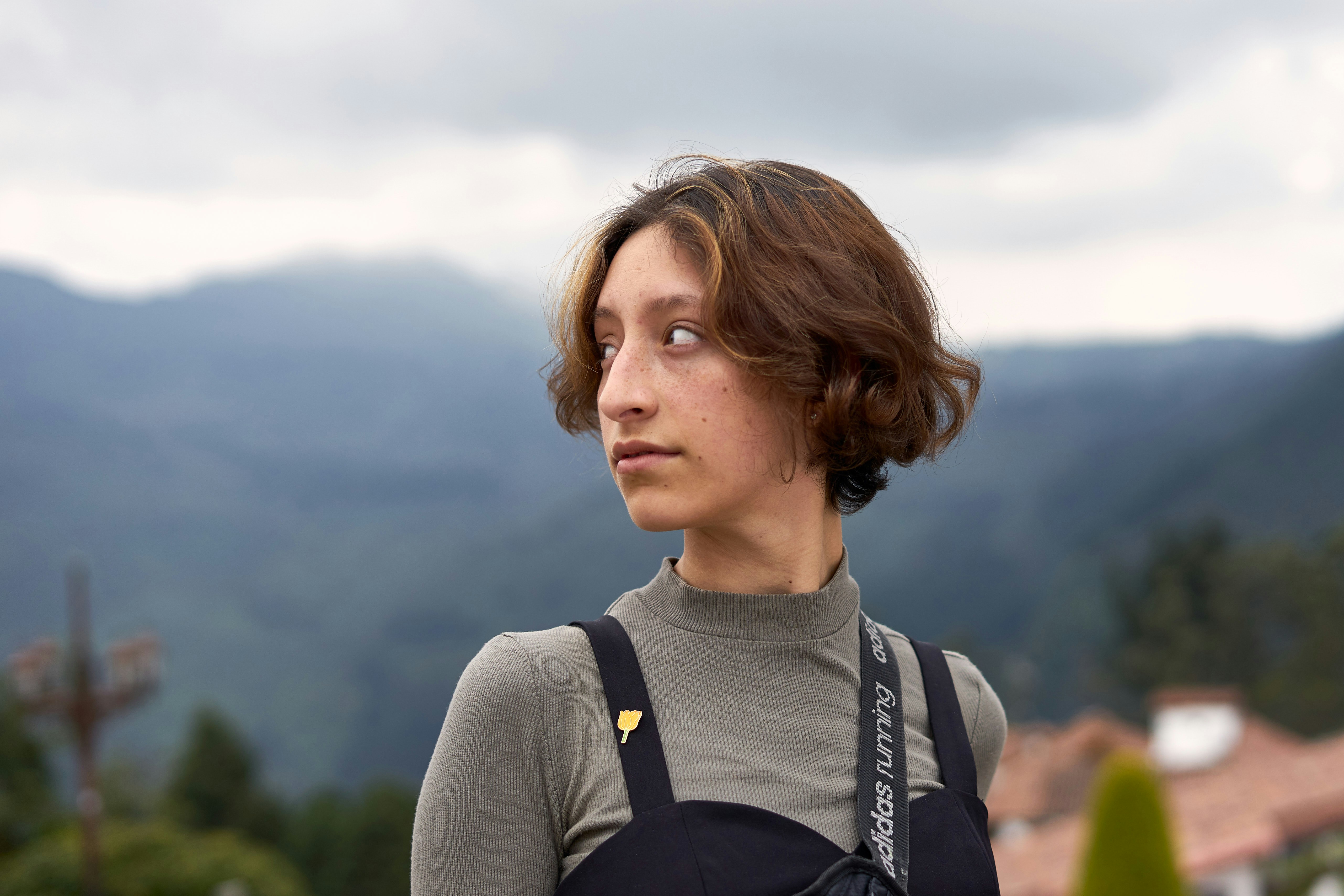 A woman standing in front of a mountain range