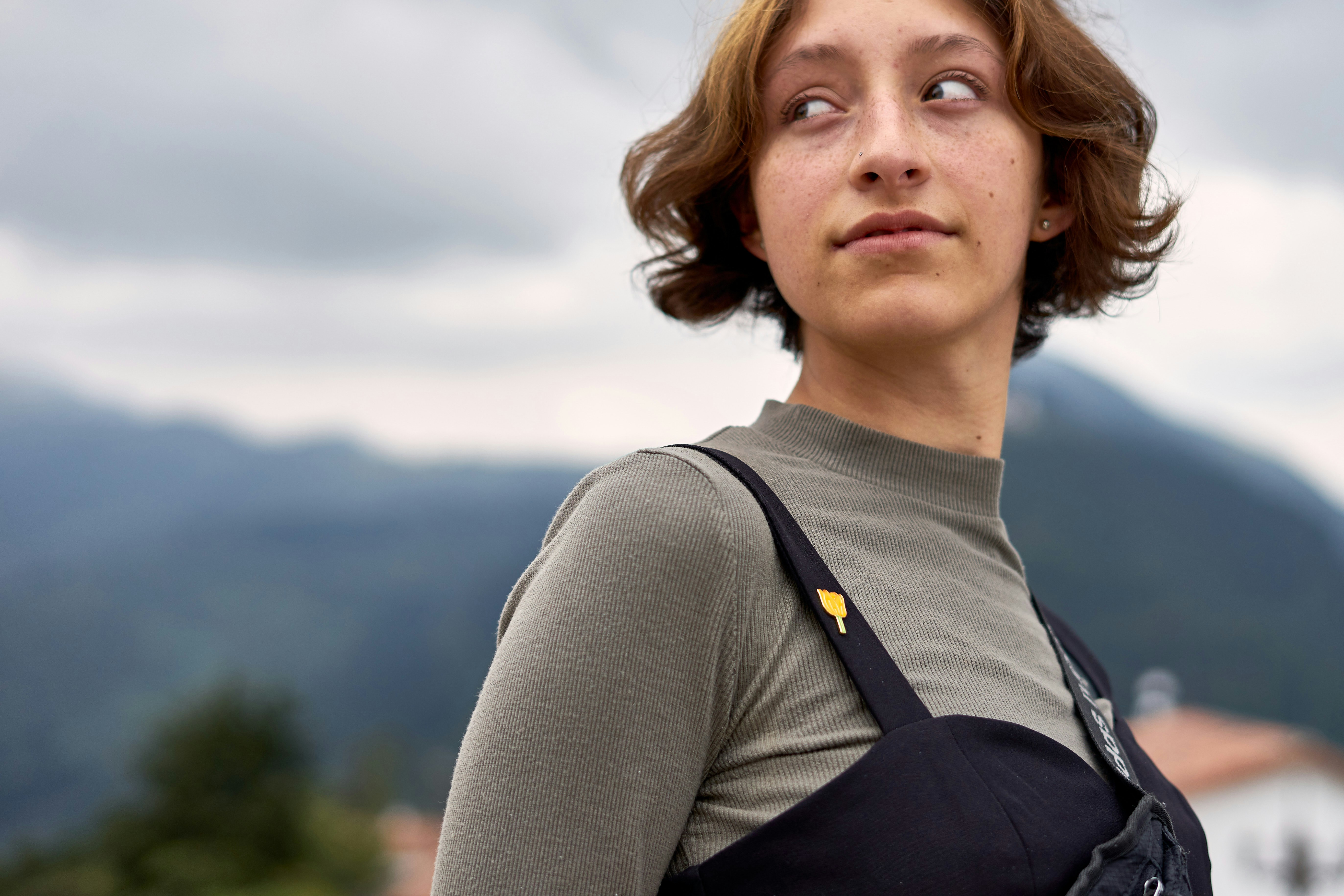 A woman standing in front of a mountain