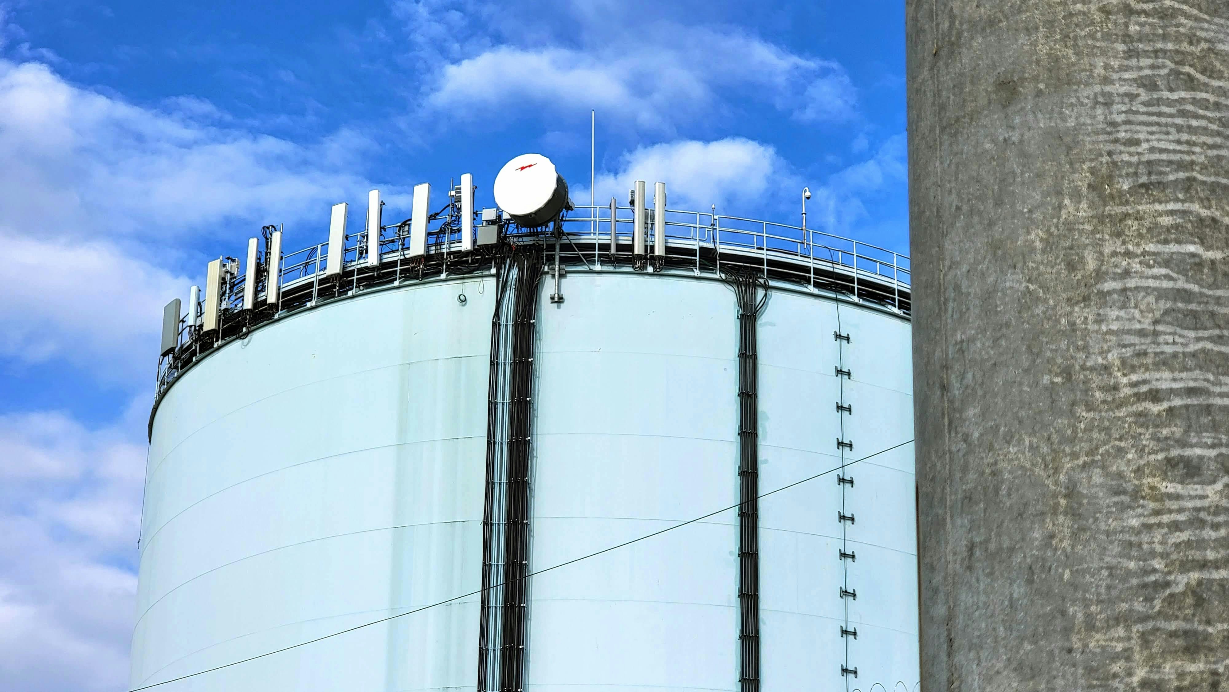 A large tank with a satellite dish on top of it