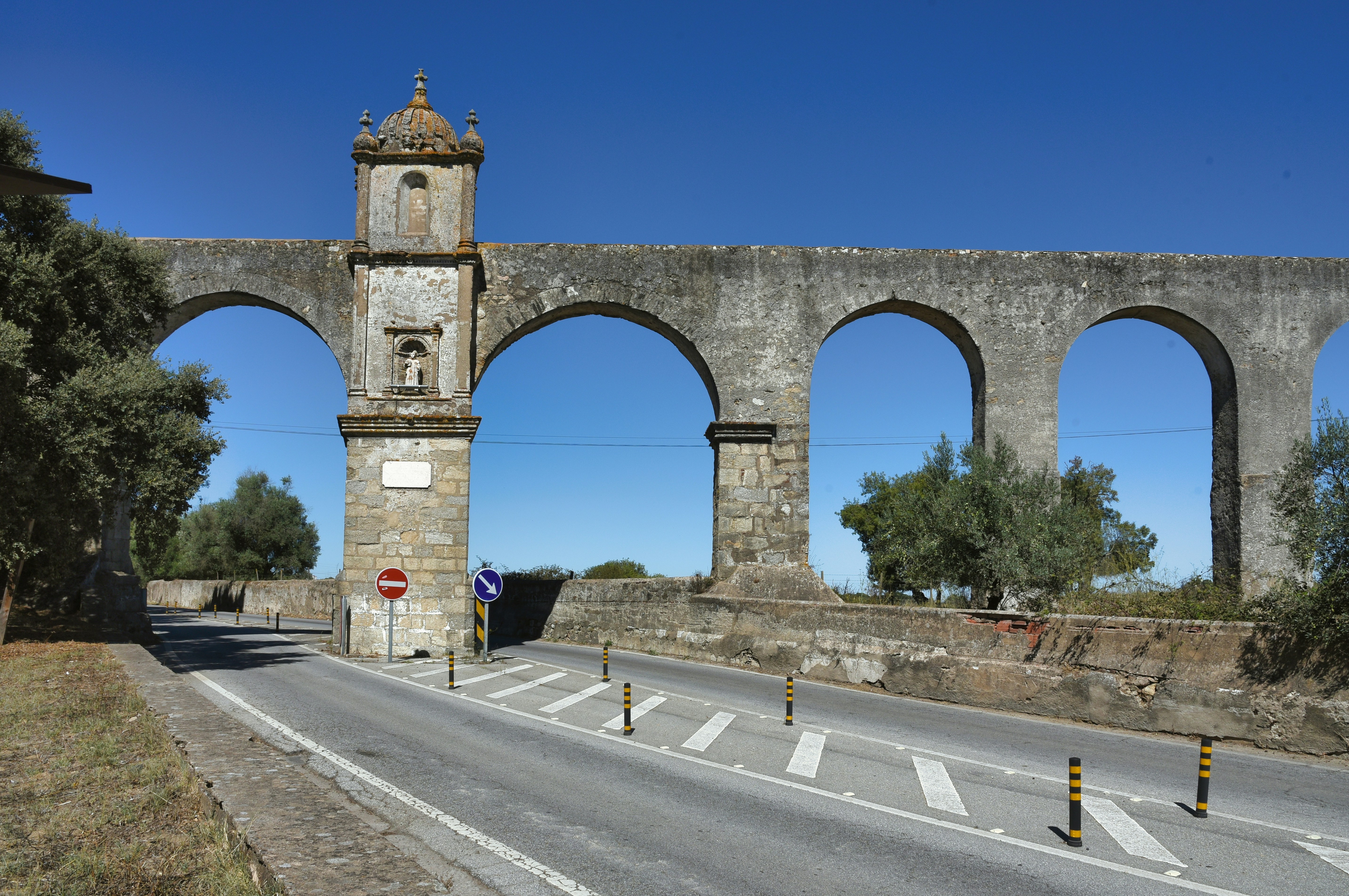 An old stone bridge with arches and a clock tower