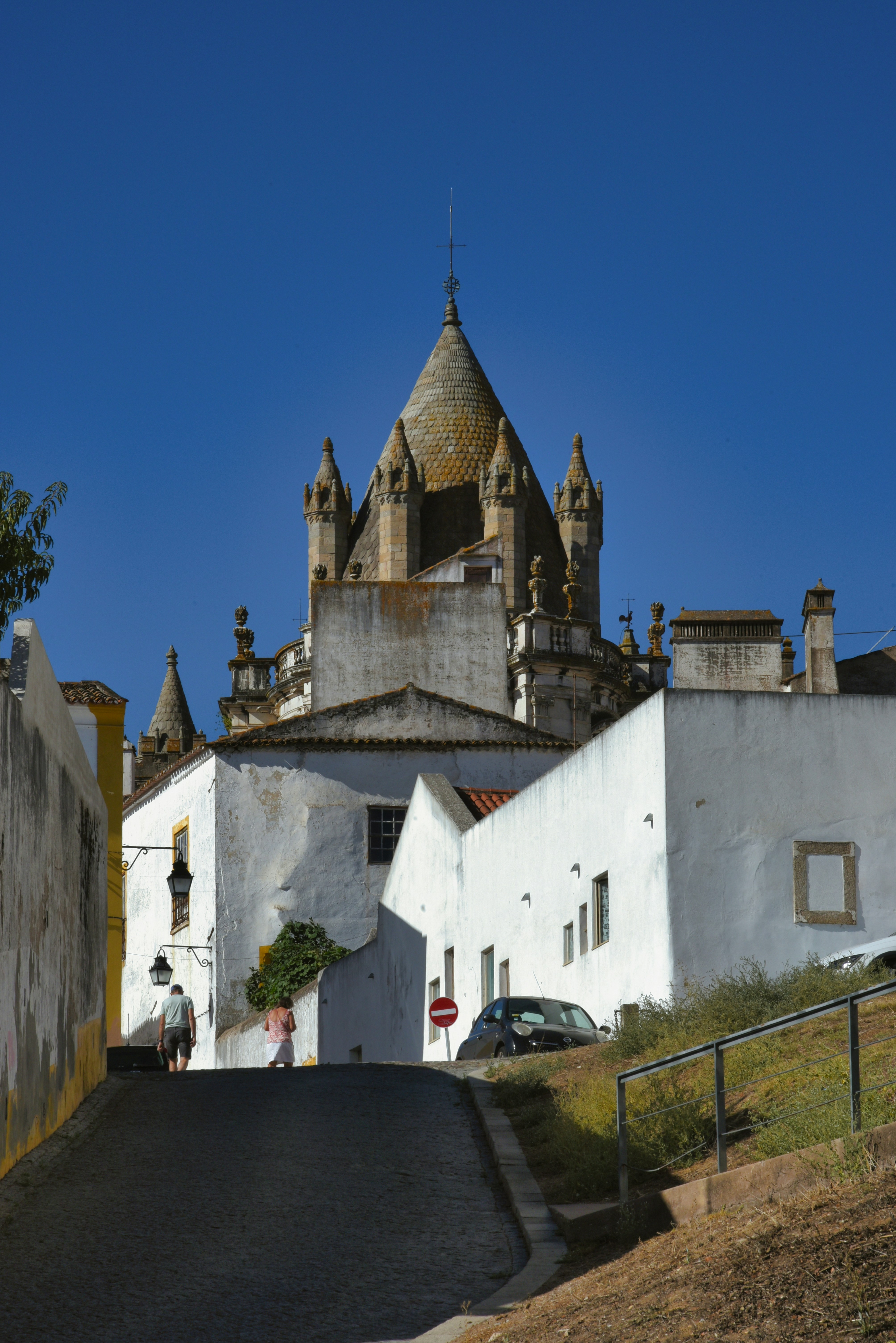 A white building with a steeple on top of it
