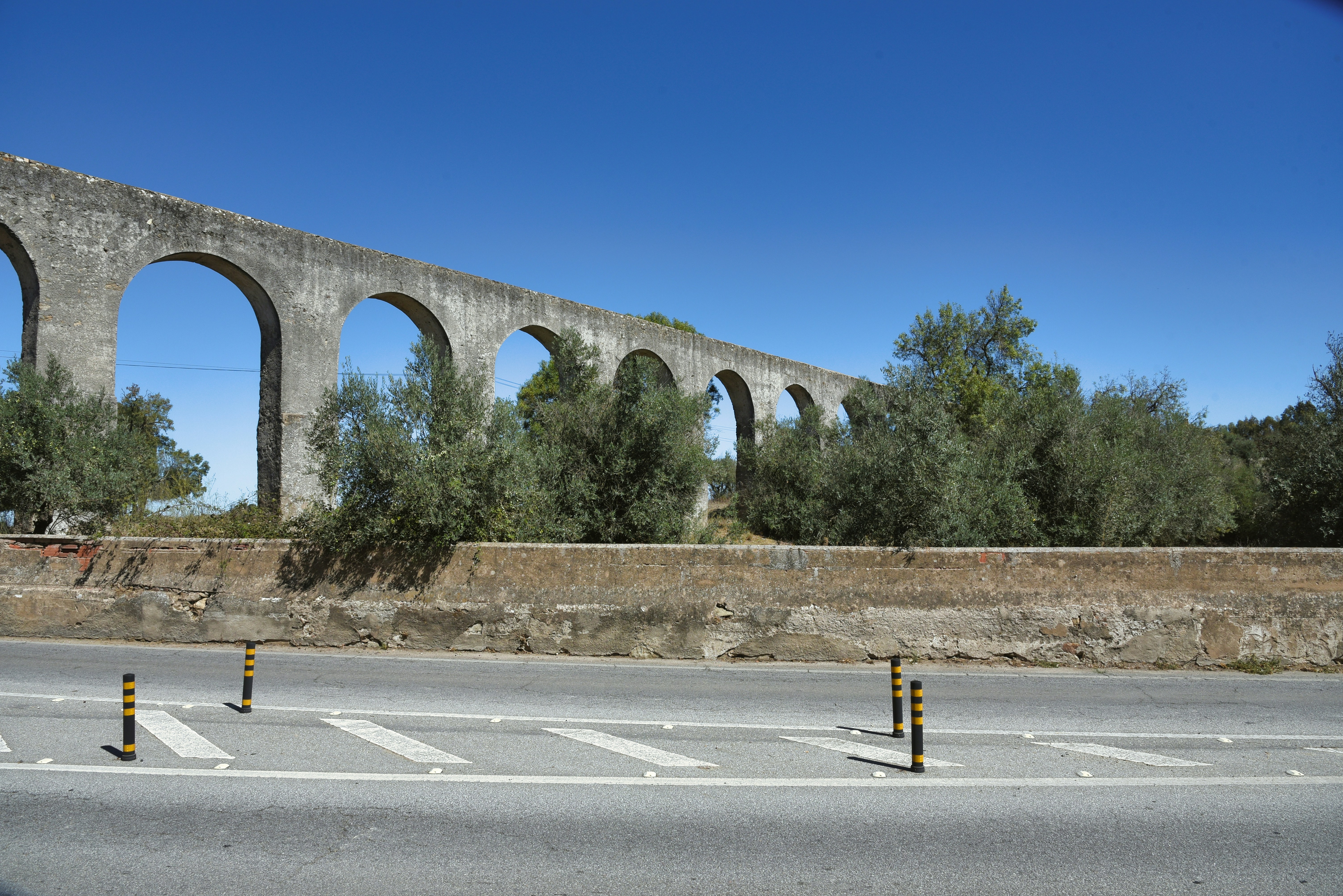 A road with a bridge in the background