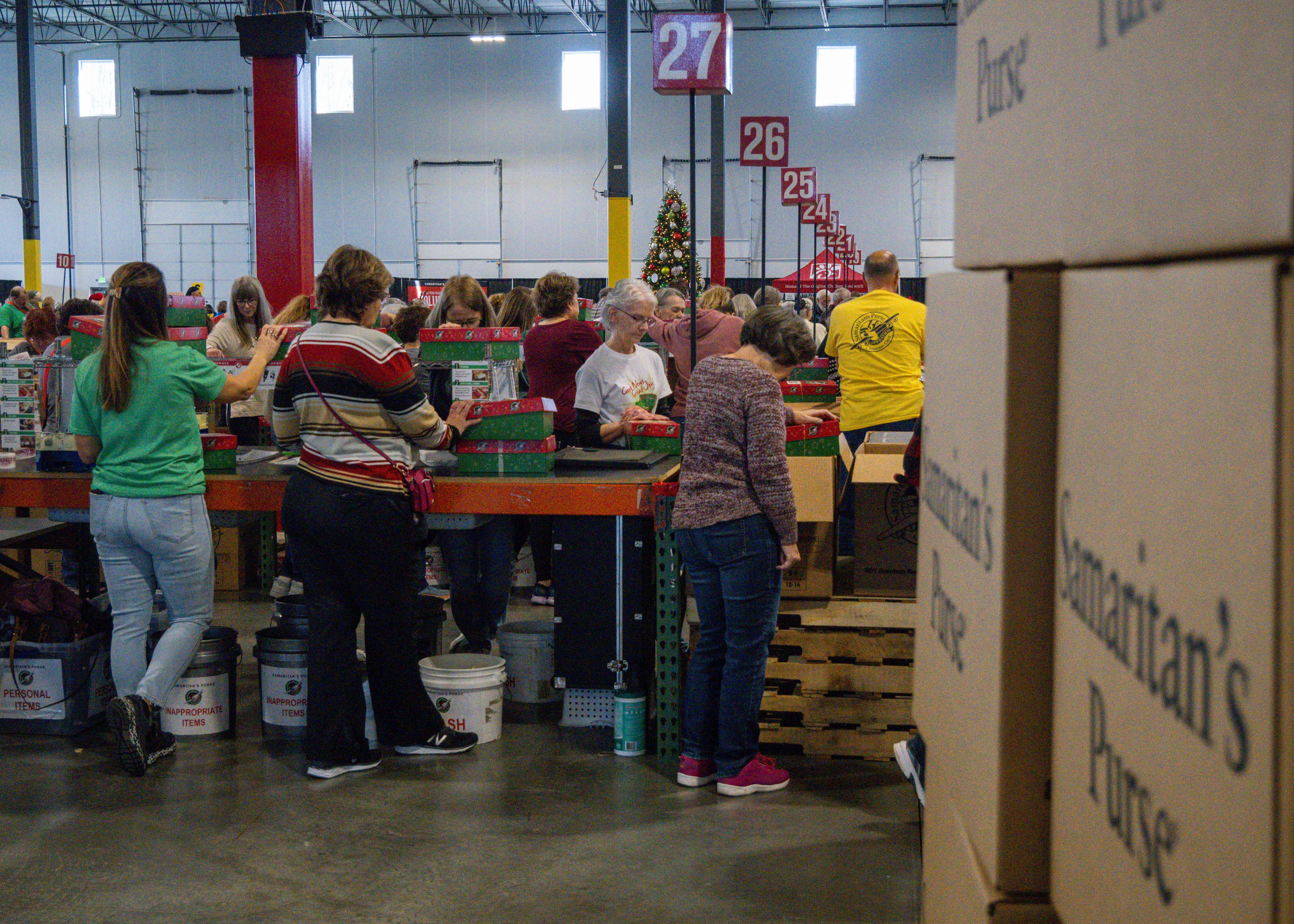 Warehouse with rows of branded gift boxes ready for multi-address dispatch on white background