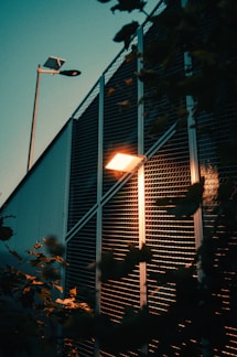 A street light sitting next to a tall building