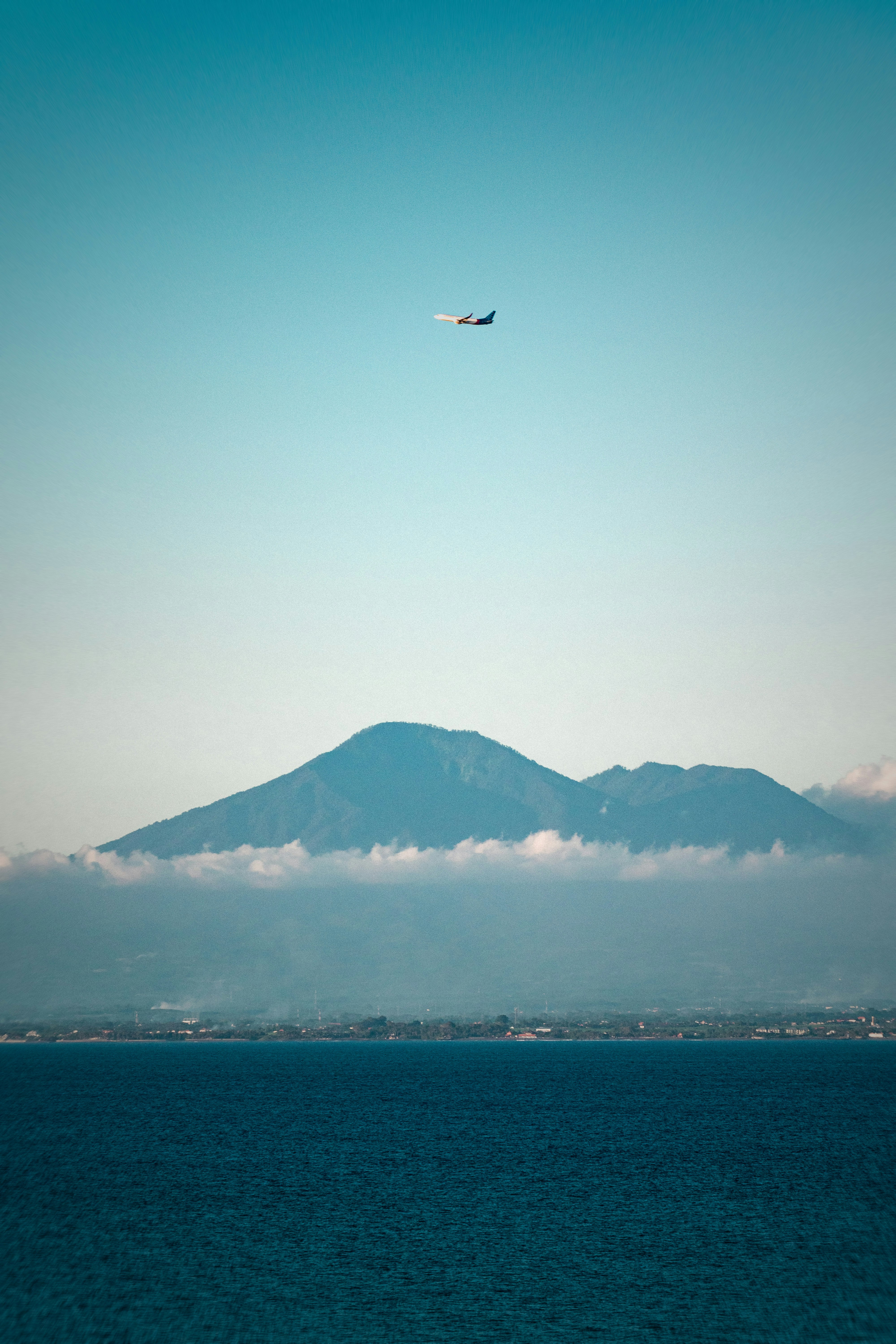 A plane flying over a large body of water