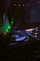 A dj mixing music in a tent at night