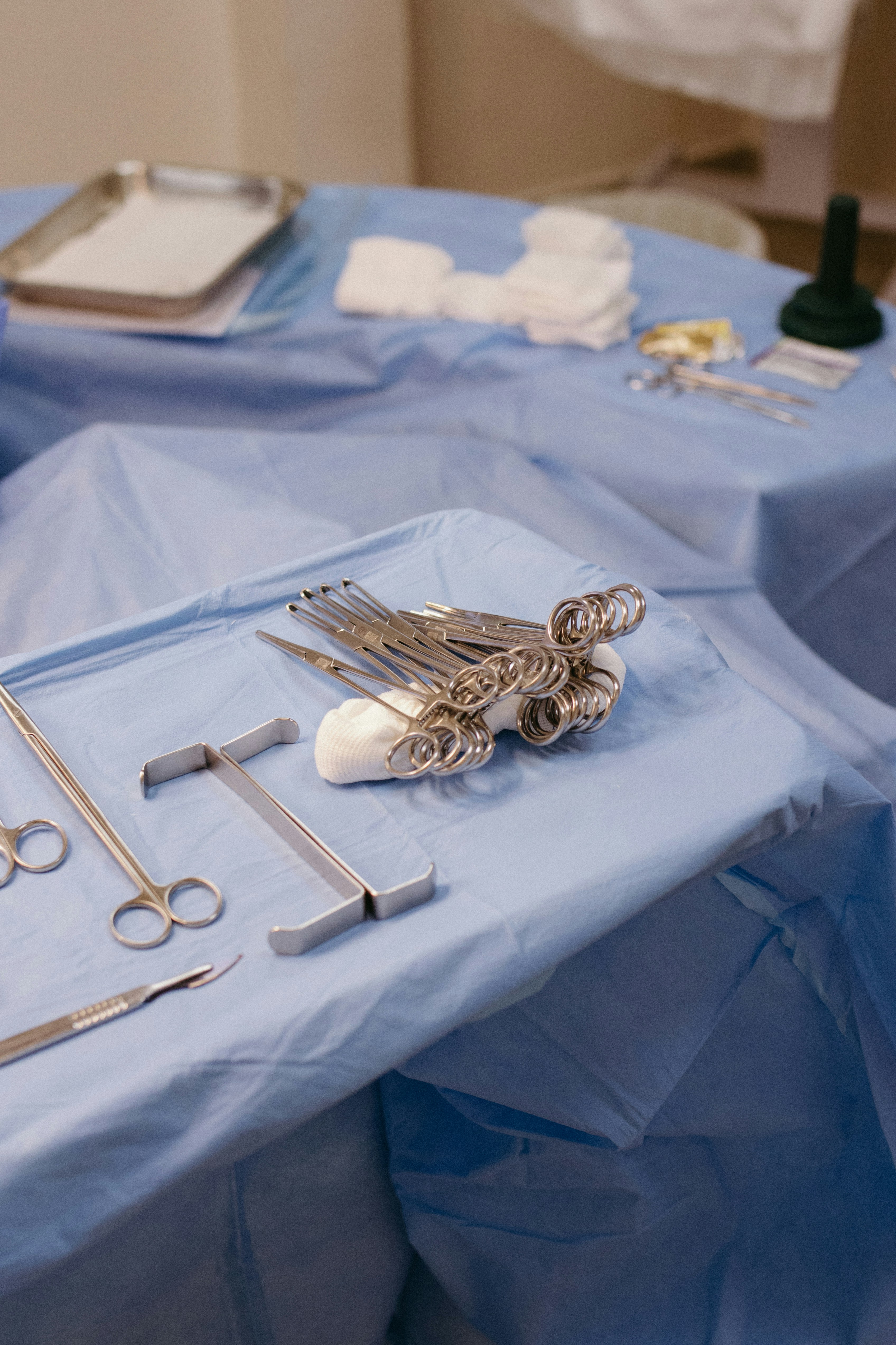 A table topped with surgical equipment on top of a blue table cloth