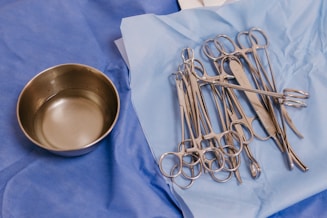 A table topped with lots of surgical instruments