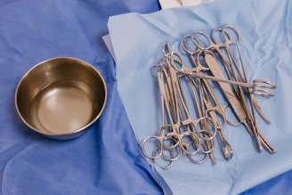 A table topped with lots of surgical instruments
