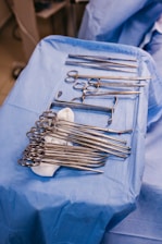 A table topped with lots of surgical tools