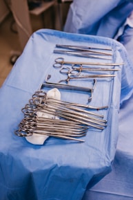 A table topped with lots of surgical tools