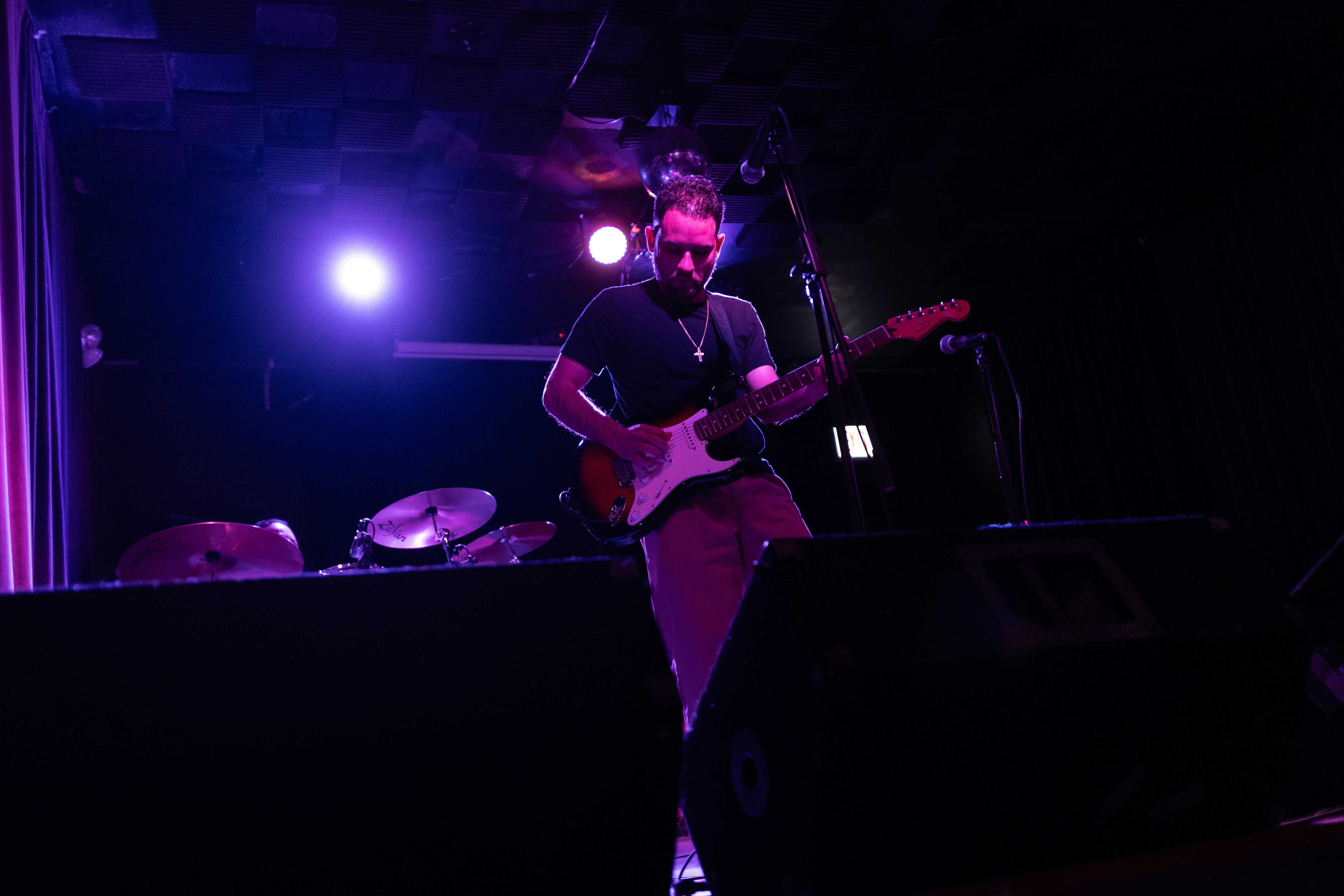 Musician playing guitar on stage